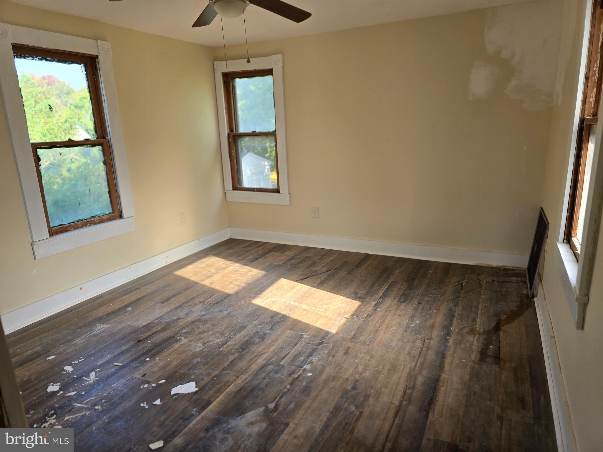 40 Maple Street Crisfield, MD 21817 - Photo 10 of 14 a view of empty room with wooden floor and fan