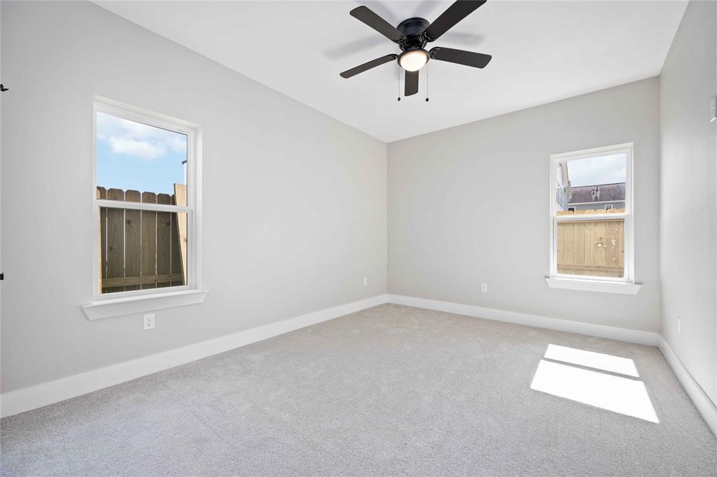 2118 Dan Street Houston, TX 77020 - Photo 18 of 35 an empty room with windows and fan