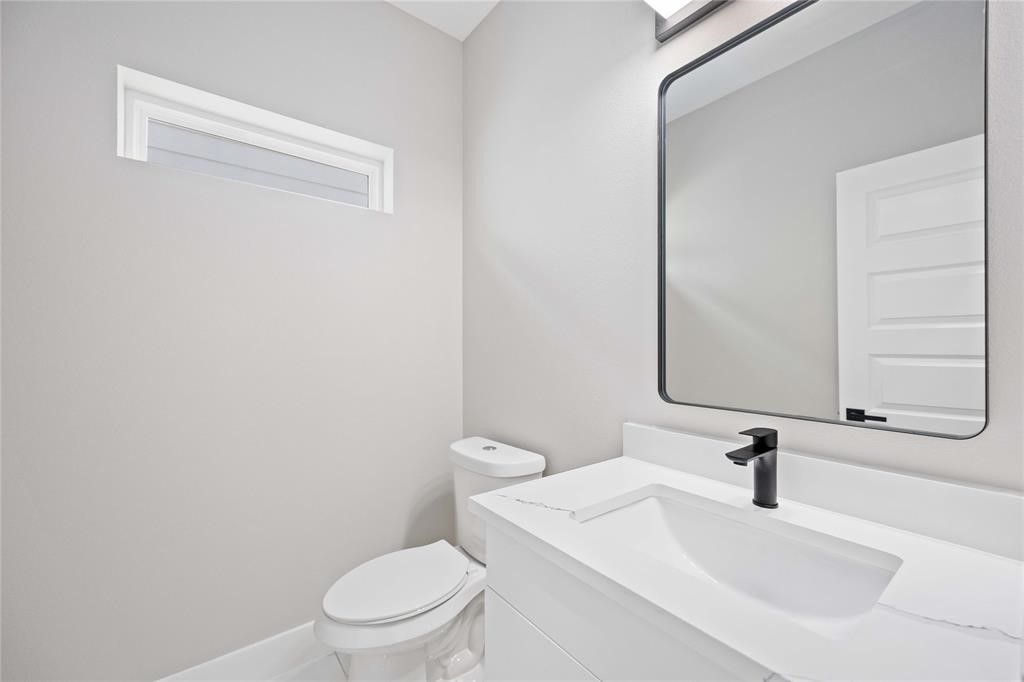 2118 Dan Street Houston, TX 77020 - Photo 20 of 35 a bathroom with a sink a toilet and a mirror