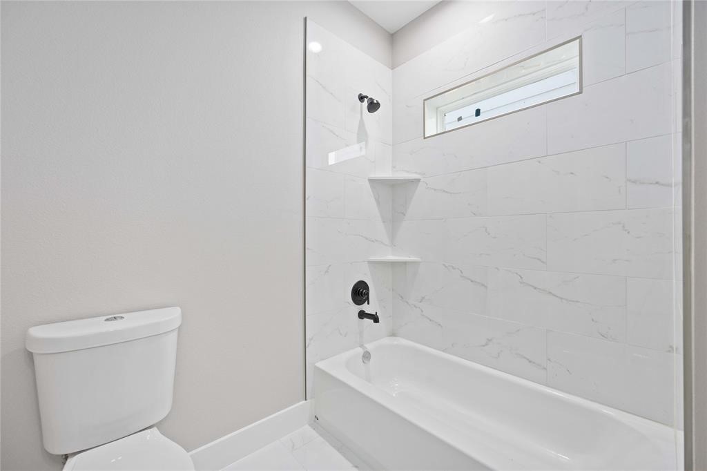2118 Dan Street Houston, TX 77020 - Photo 21 of 35 a bathroom with a bathtub a toilet and a shower