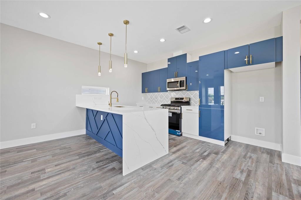 2118 Dan Street Houston, TX 77020 - Photo 25 of 35 a kitchen with stainless steel appliances granite countertop a refrigerator a sink dishwasher a stove and a oven with wooden floors