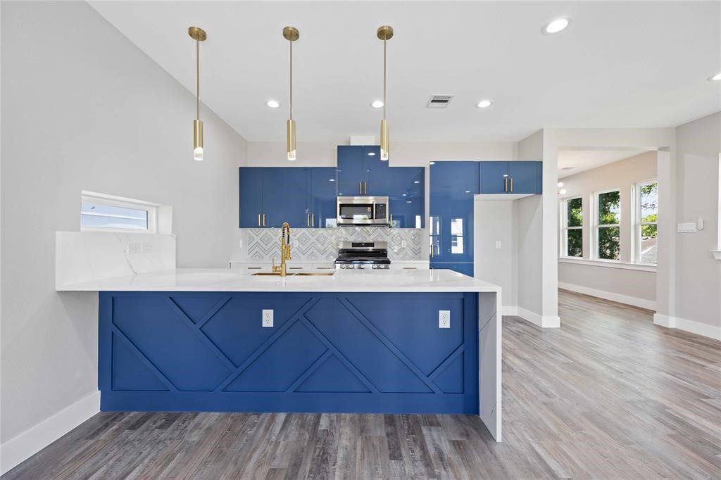 2118 Dan Street Houston, TX 77020 - Photo 26 of 35 a kitchen with stainless steel appliances granite countertop a sink a stove and a wooden floors