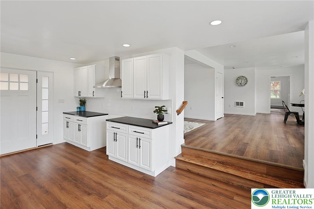 121 Ben Titus Road Tamaqua, PA 18252 - Photo 22 of 48 a kitchen with stainless steel appliances white cabinets and wooden floor