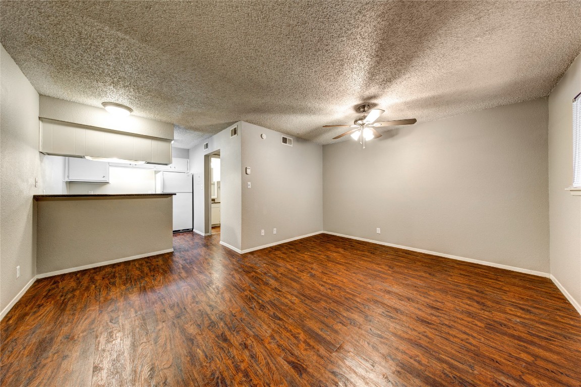 4520 Duval Street, Unit 102 Austin, TX 78751 - Photo 6 of 9 a view of a room with wooden floor and a ceiling fan