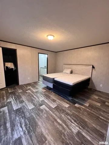 a bedroom with a bed and a mirror