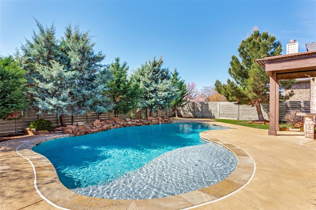 1505 5th Street Argyle, TX 76226 - Photo 24 of 25 a view of a swimming pool with a sitting space