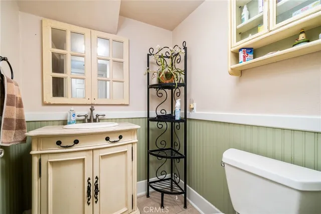 a bathroom with a toilet a sink and a mirror