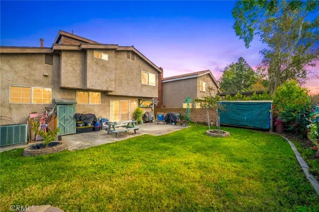a view of a house with a yard and sitting area