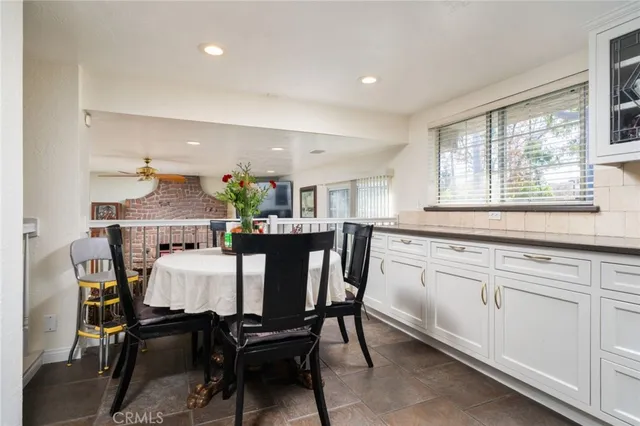 a view of a dining room with furniture and a window