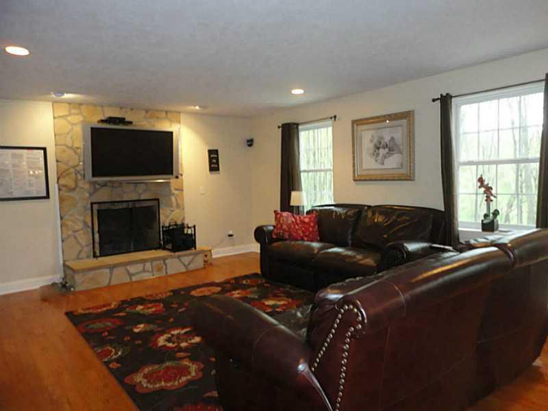 264 Steiner Bridge Road Valencia, PA 16059 - Photo 3 of 25 Den/Family/Great Room. The cook does not have to miss the fireplace and family activities in this open floor plan. Plus, the large windows allow for enjoying the gorgeous view.