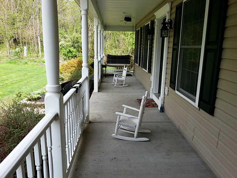 264 Steiner Bridge Road Valencia, PA 16059 - Photo 24 of 25 Exterior Front. A front porch swing beckons to enjoy the summer breezes.