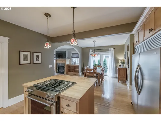 a kitchen with kitchen island a stove and a wooden floor