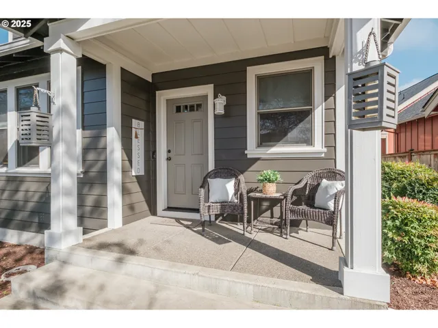 a backyard of a house with table and chairs