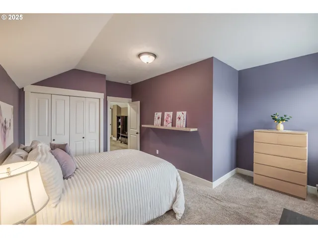 a bedroom with a bed and a couch