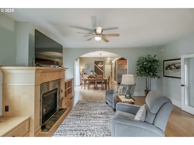 a living room with furniture a flat screen tv and a fireplace