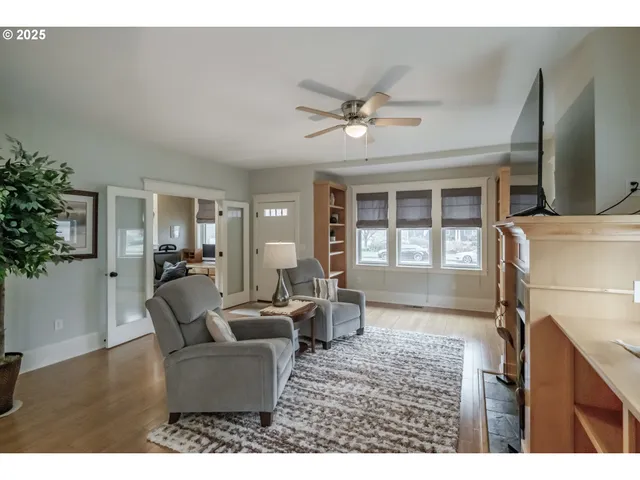 a living room with furniture a chandelier and a window