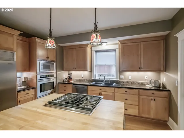 a kitchen with a stove a sink and a refrigerator