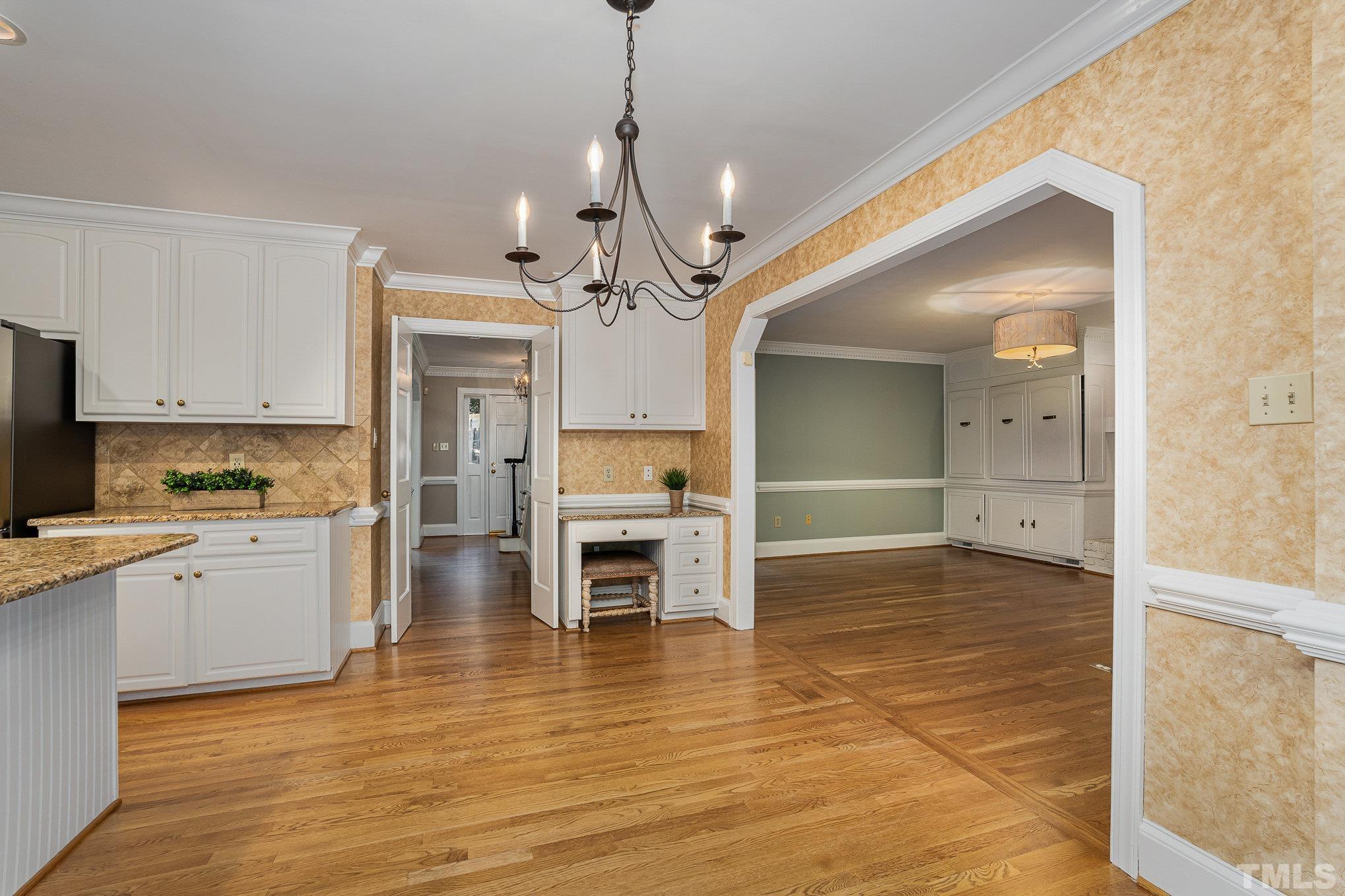 12036 Warwickshire Way Raleigh, NC 27613 - Photo 12 of 40 a view of a kitchen with wooden floor and a kitchen