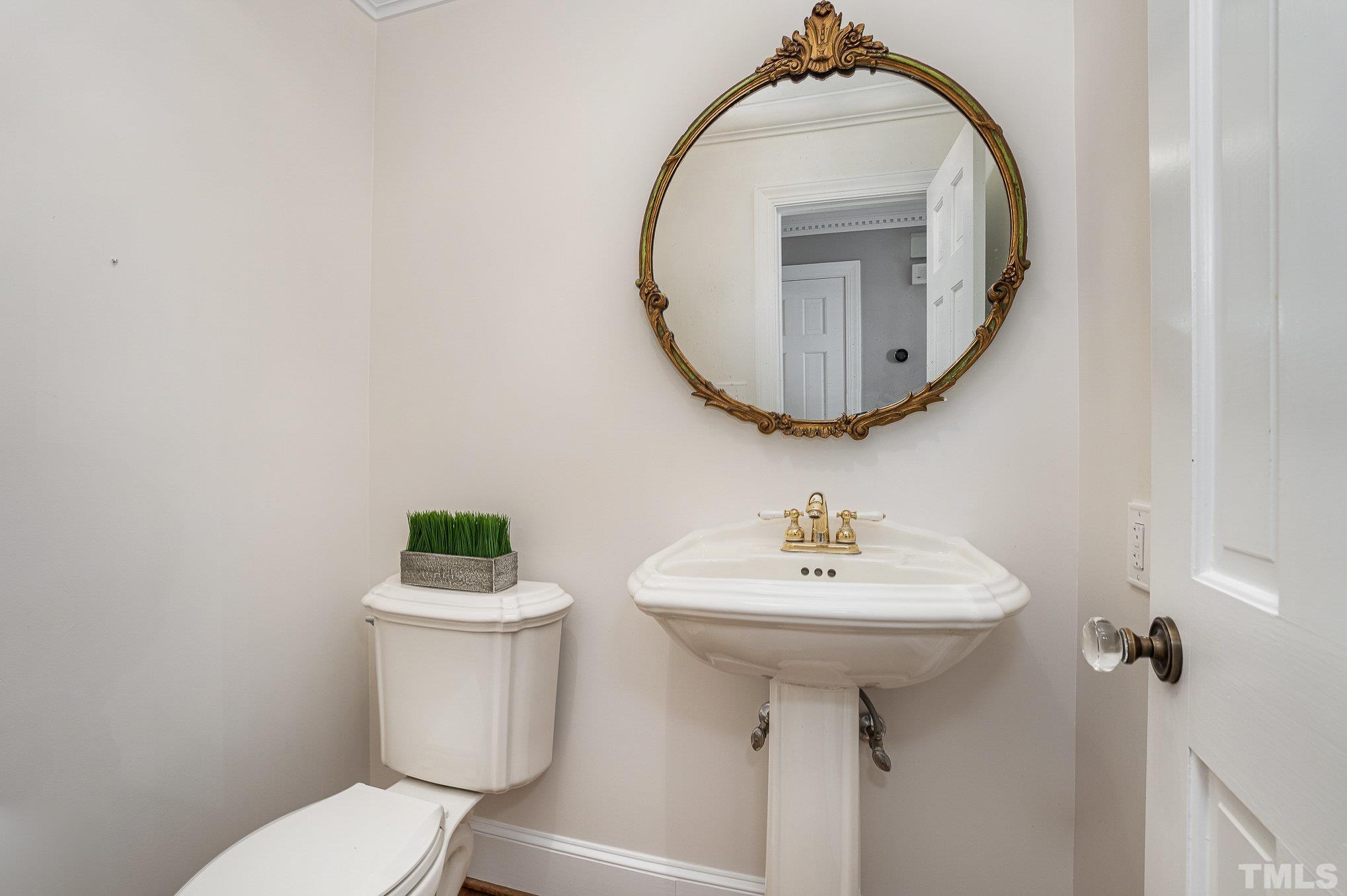 12036 Warwickshire Way Raleigh, NC 27613 - Photo 15 of 40 a bathroom with a sink a mirror and toilet