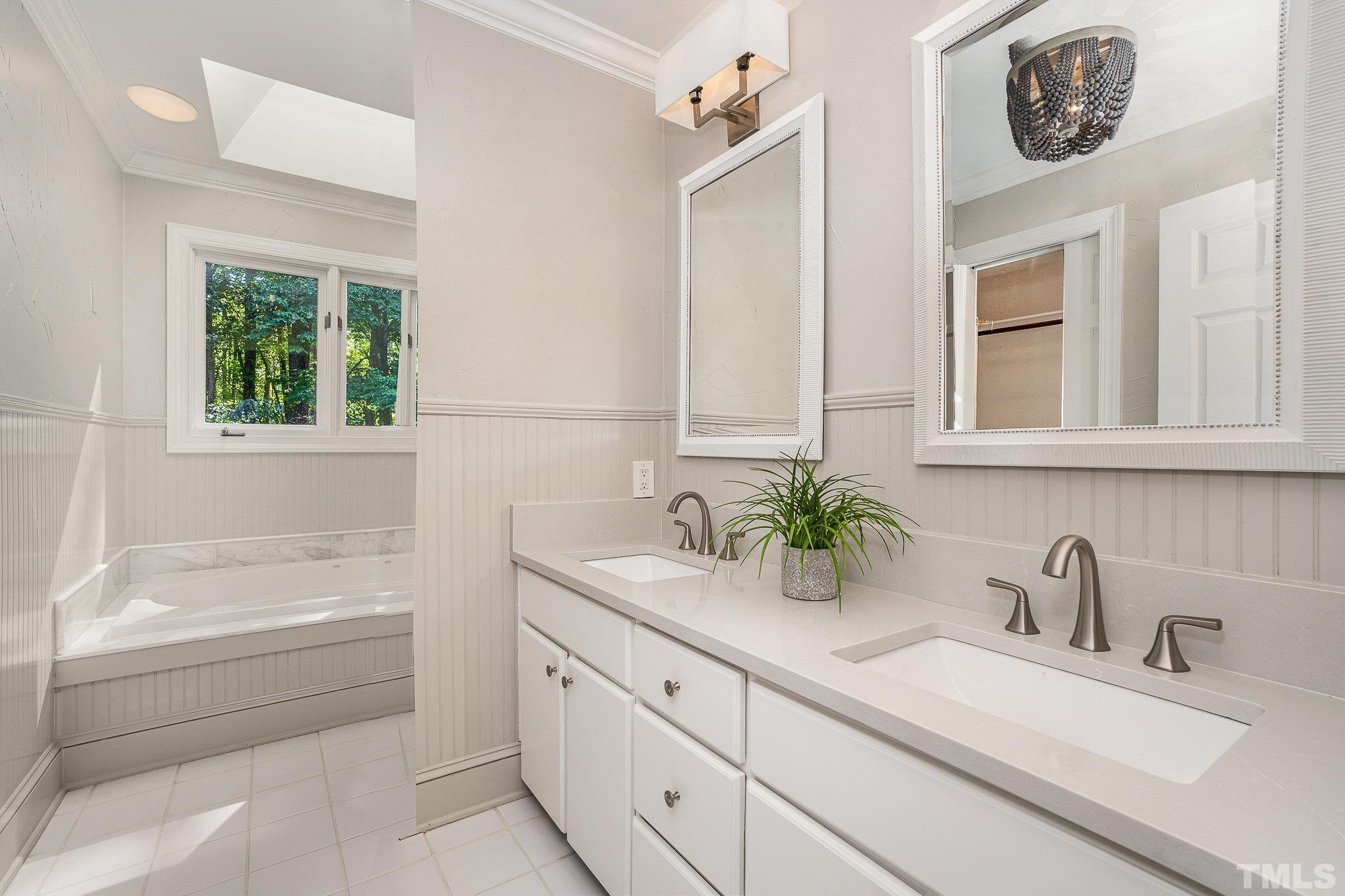 12036 Warwickshire Way Raleigh, NC 27613 - Photo 18 of 40 a bathroom with a sink and a bathtub