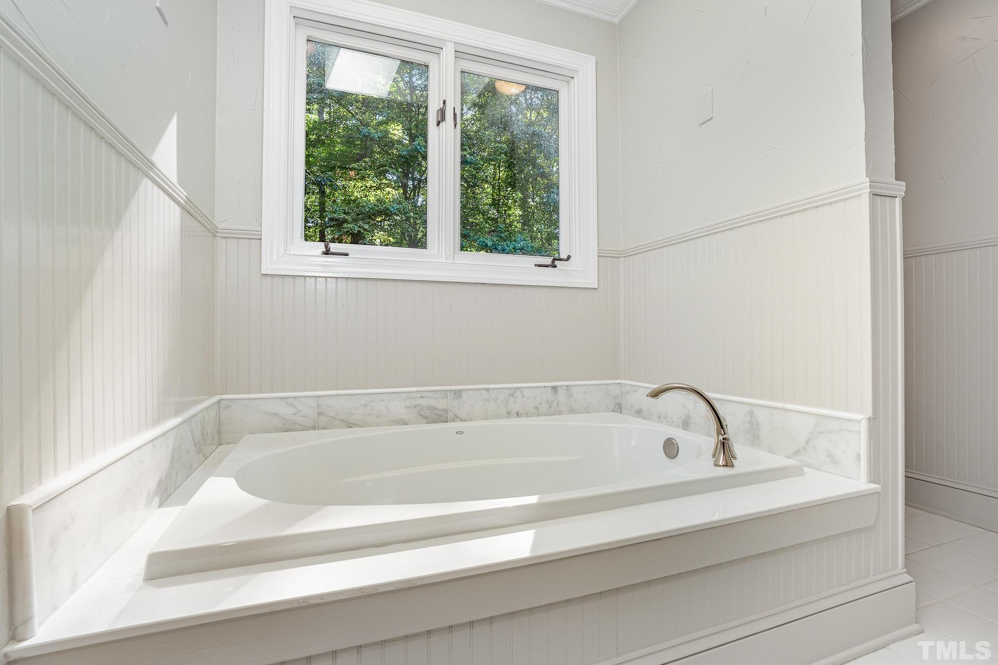 12036 Warwickshire Way Raleigh, NC 27613 - Photo 20 of 40 a white bath tub sitting next to a window