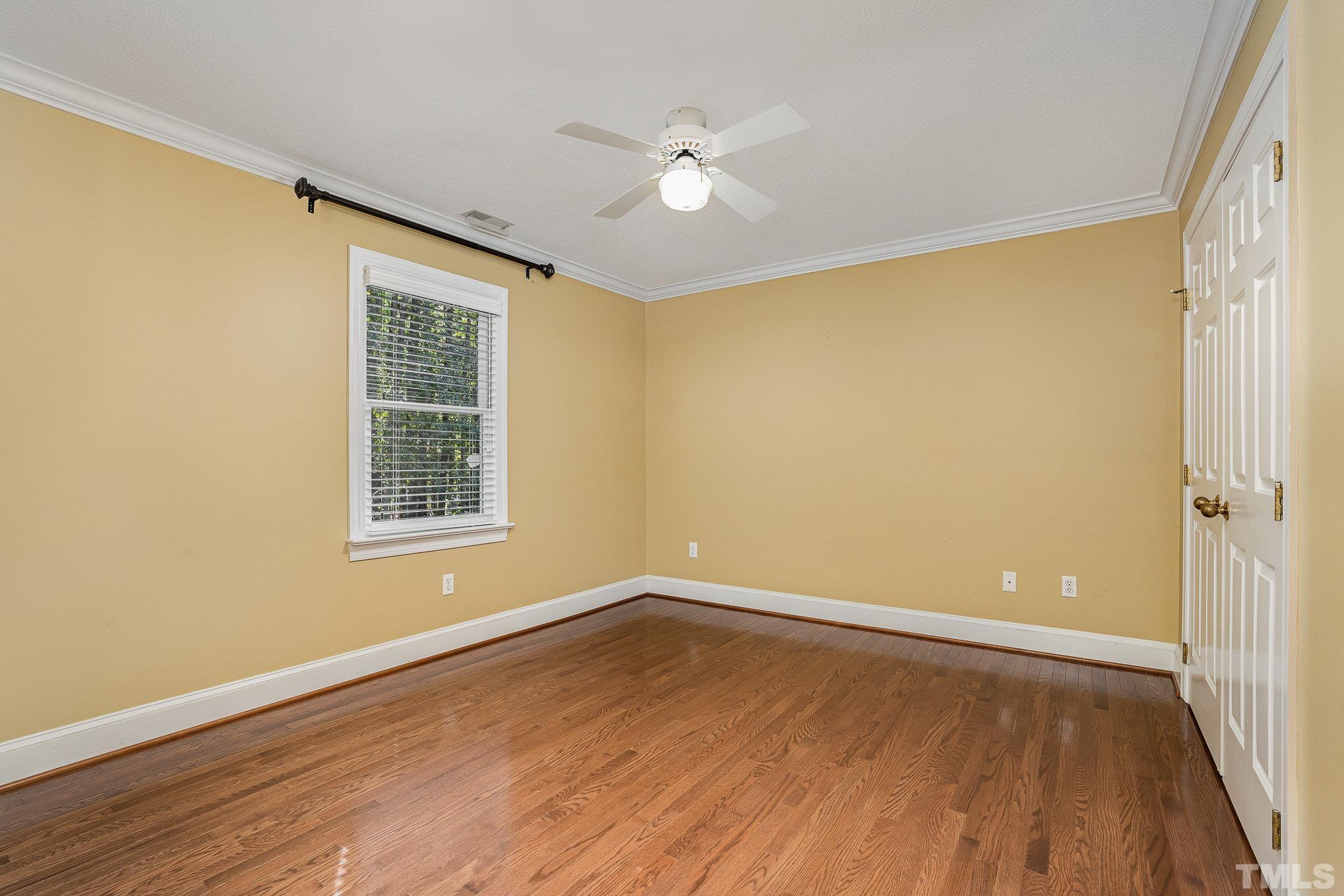 12036 Warwickshire Way Raleigh, NC 27613 - Photo 22 of 40 an empty room with wooden floor and windows