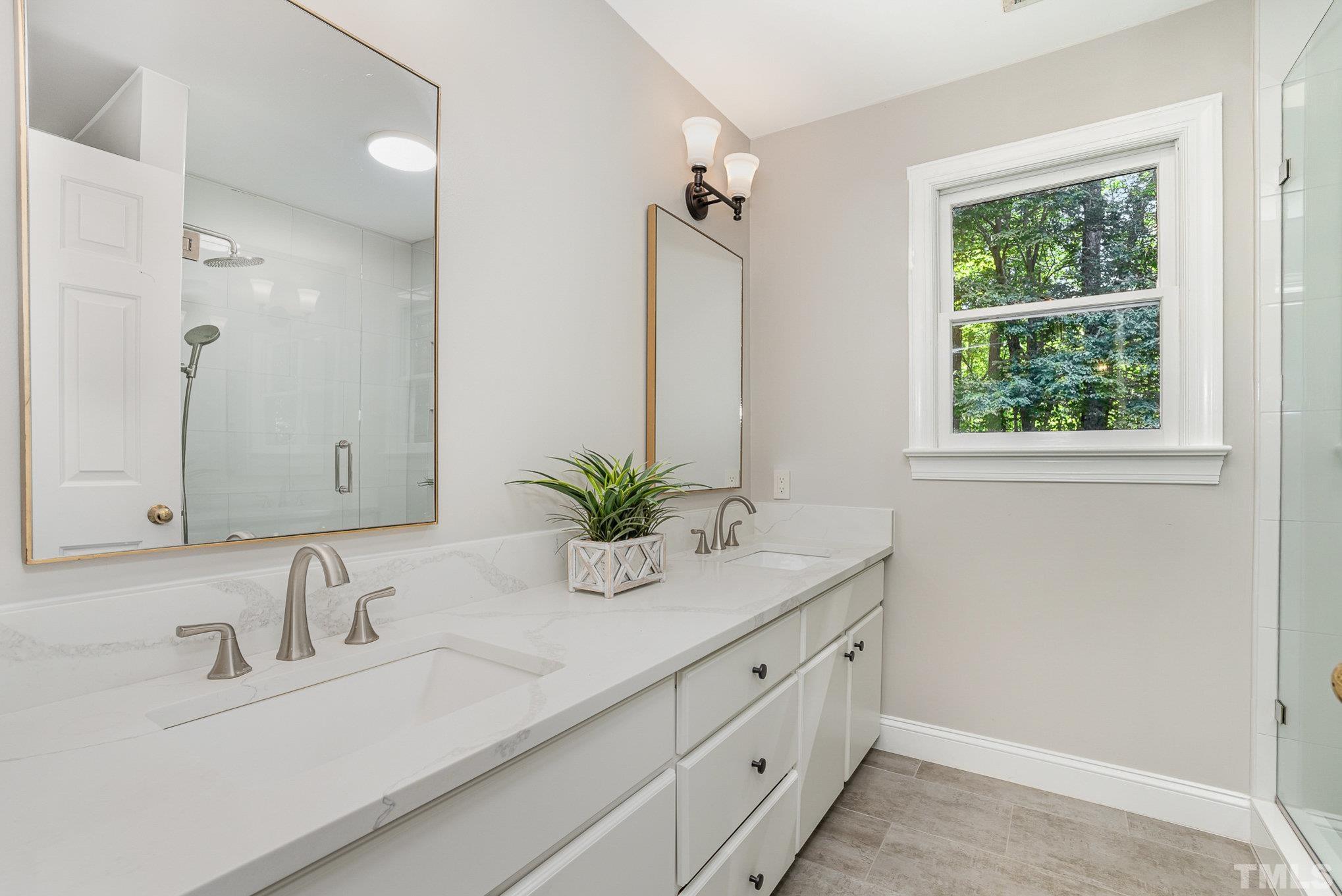 12036 Warwickshire Way Raleigh, NC 27613 - Photo 23 of 40 a bathroom with a sink and a mirror