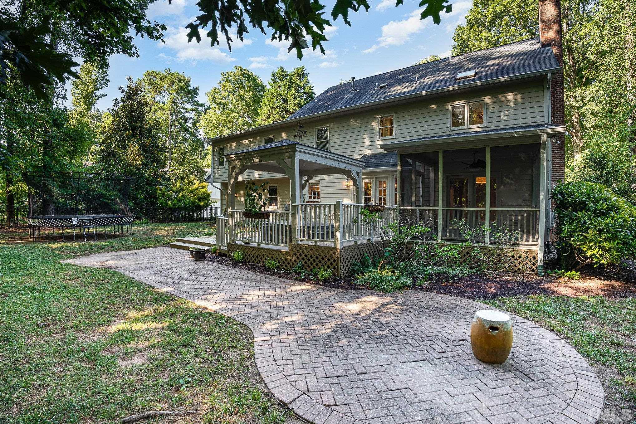 12036 Warwickshire Way Raleigh, NC 27613 - Photo 28 of 40 a view of a house with backyard sitting area and garden