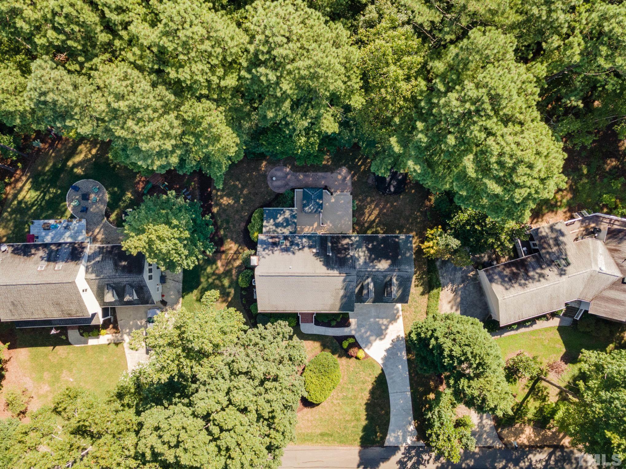 12036 Warwickshire Way Raleigh, NC 27613 - Photo 33 of 40 a view of a patio with table and chairs potted plants and large tree