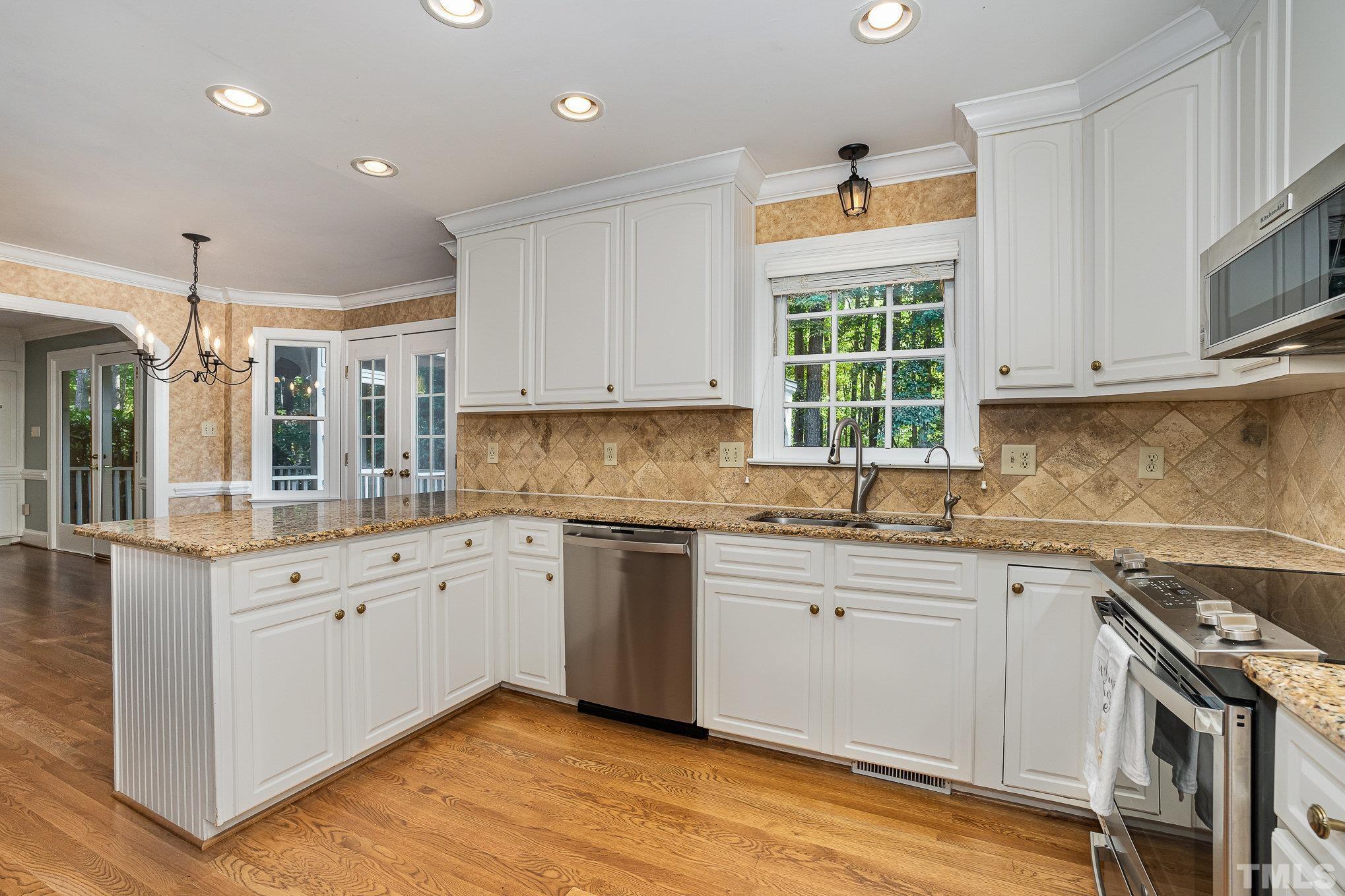 12036 Warwickshire Way Raleigh, NC 27613 - Photo 7 of 40 a kitchen that has a sink and a stove in it