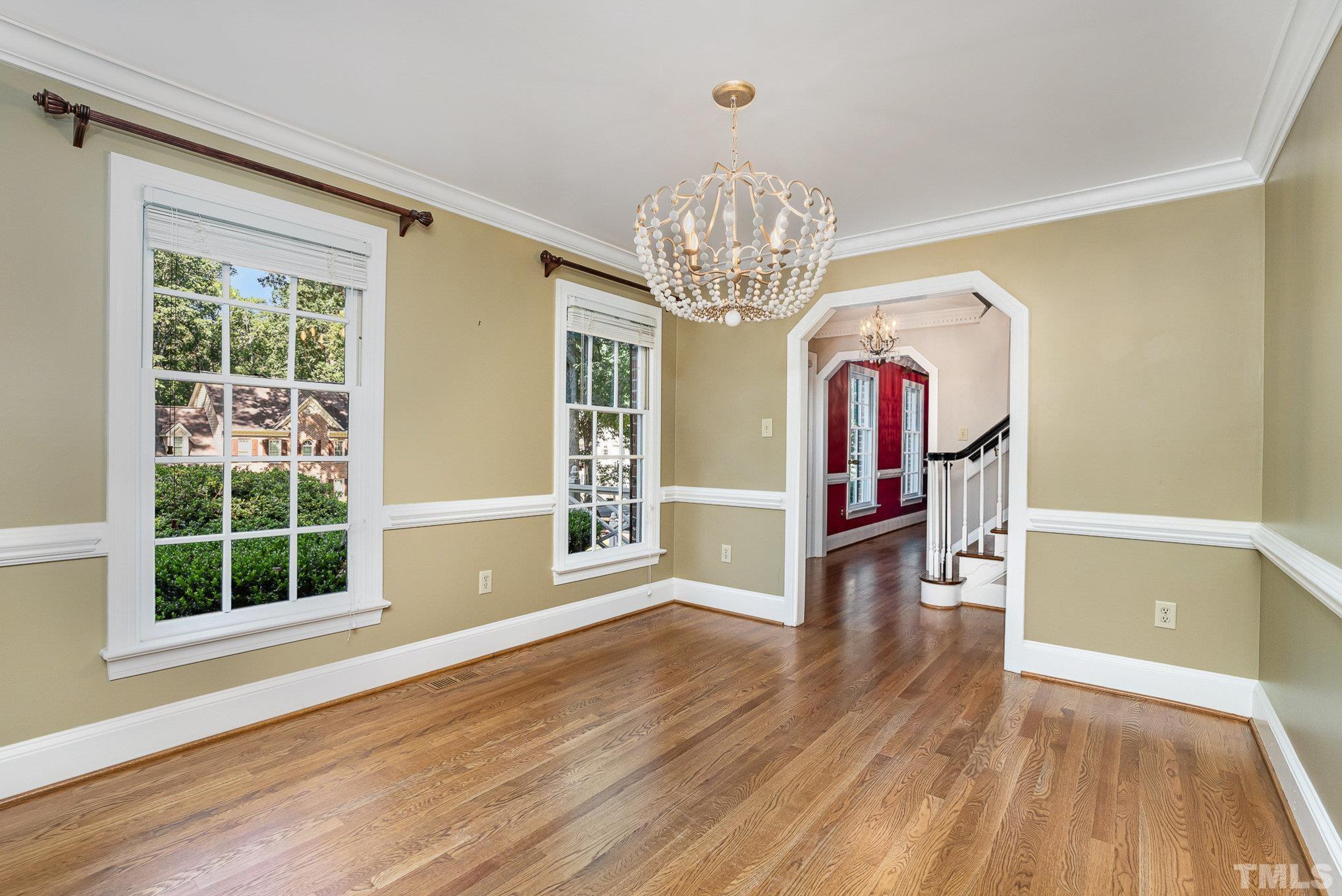 12036 Warwickshire Way Raleigh, NC 27613 - Photo 8 of 40 a view of livingroom with chandelier and wooden floor