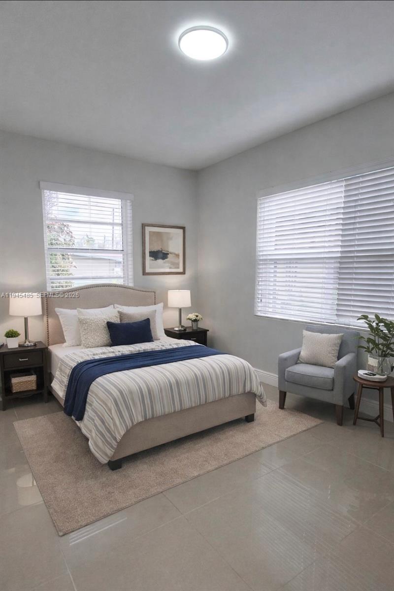 75 Southwest 32nd Court Road Miami, FL 33135 - Photo 14 of 53 a bedroom with bed couch and window