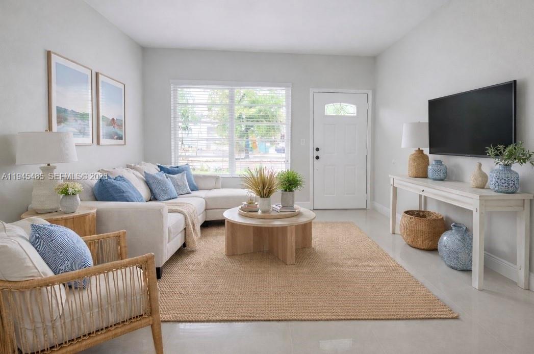 75 Southwest 32nd Court Road Miami, FL 33135 - Photo 2 of 53 a living room with furniture and a flat screen tv