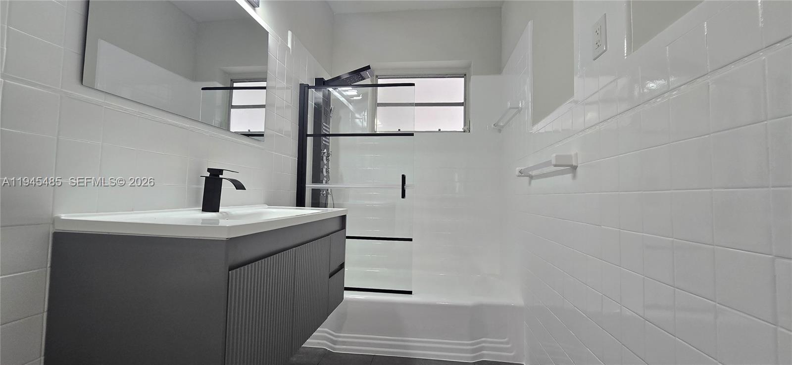 75 Southwest 32nd Court Road Miami, FL 33135 - Photo 27 of 53 a bathroom with a sink and mirror