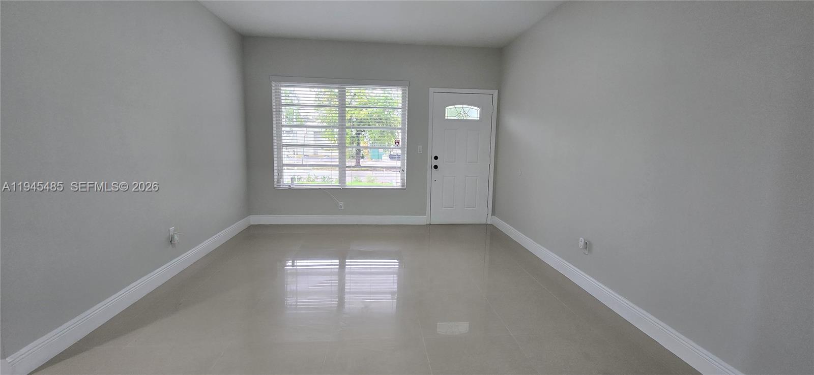 75 Southwest 32nd Court Road Miami, FL 33135 - Photo 3 of 53 an empty room with a window