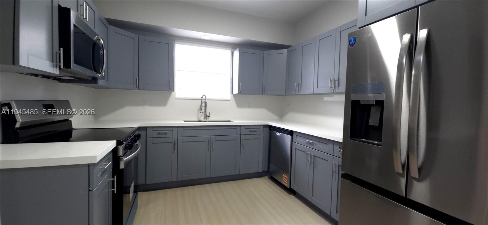 75 Southwest 32nd Court Road Miami, FL 33135 - Photo 31 of 53 a kitchen with stainless steel appliances granite countertop a refrigerator sink and microwave