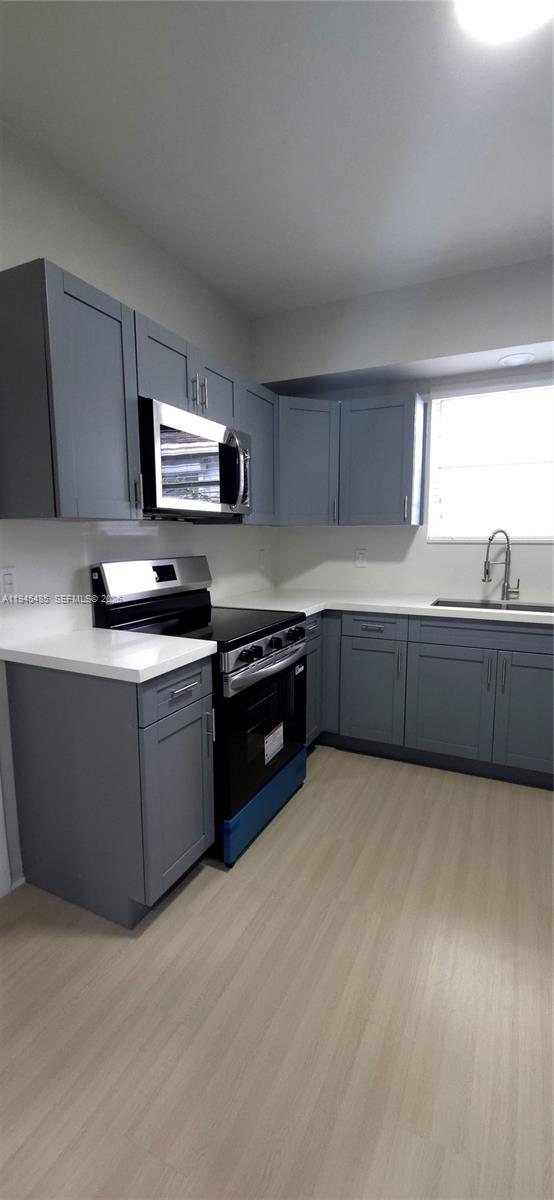 75 Southwest 32nd Court Road Miami, FL 33135 - Photo 34 of 53 a kitchen with stainless steel appliances granite countertop a sink and a stove