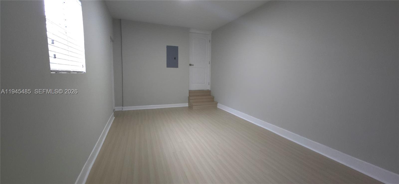 75 Southwest 32nd Court Road Miami, FL 33135 - Photo 37 of 53 an empty room with wooden floor and windows