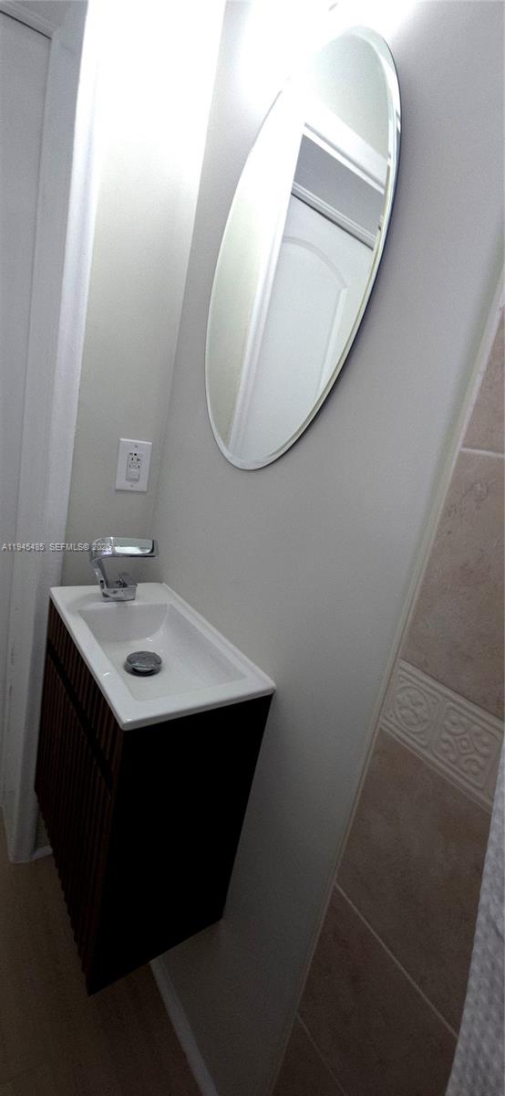 75 Southwest 32nd Court Road Miami, FL 33135 - Photo 42 of 53 a bathroom with a sink and a mirror