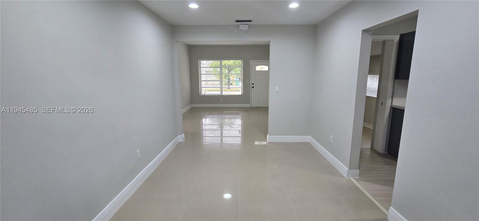 75 Southwest 32nd Court Road Miami, FL 33135 - Photo 5 of 53 wooden floor in an empty room with a window