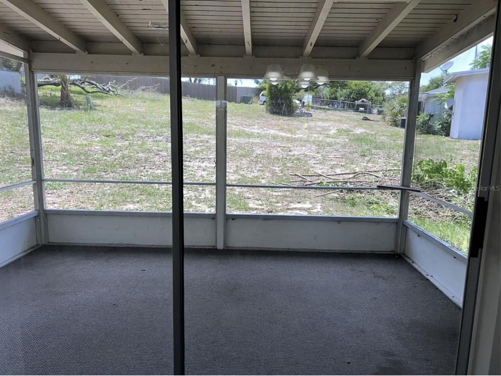 1241 Pilgrim Road Spring Hill, FL 34606 - Photo 23 of 28 a view of an empty room with a window