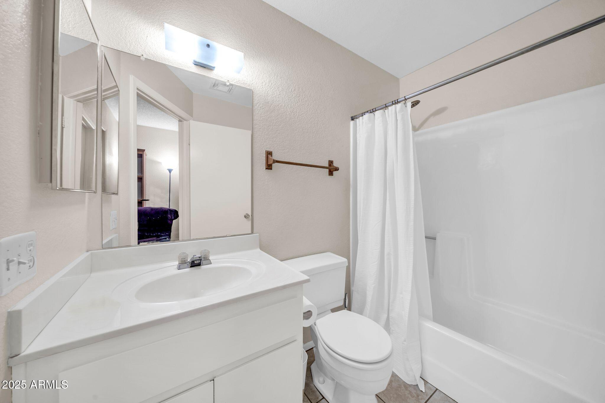14300 West Bell Road, Unit 83 Surprise, AZ 85374 - Photo 14 of 22 a bathroom with a sink toilet and shower