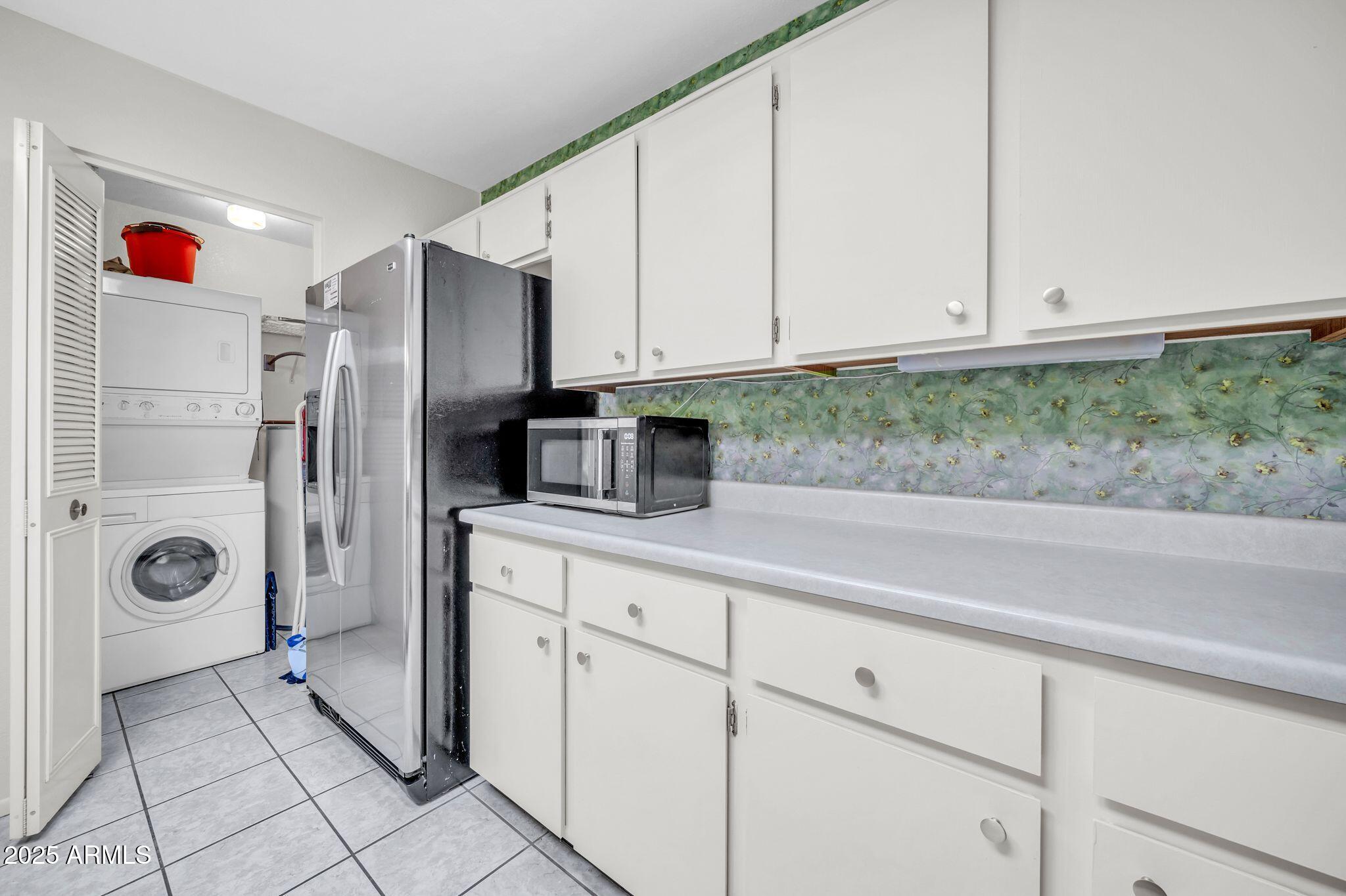 14300 West Bell Road, Unit 83 Surprise, AZ 85374 - Photo 7 of 22 a kitchen with stainless steel appliances white cabinets and a refrigerator