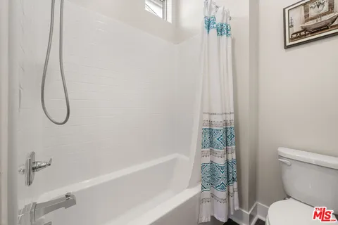 a bathroom with a shower and a toilet