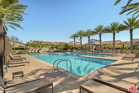 a view of a swimming pool with outdoor seating and ocean