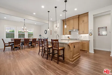 a large kitchen with lots of counter space and dining table