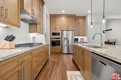 a kitchen with refrigerator a sink and cabinets