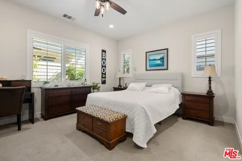 a spacious bedroom with a bed and a window