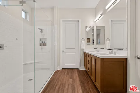 a bathroom with a double vanity sink and mirror
