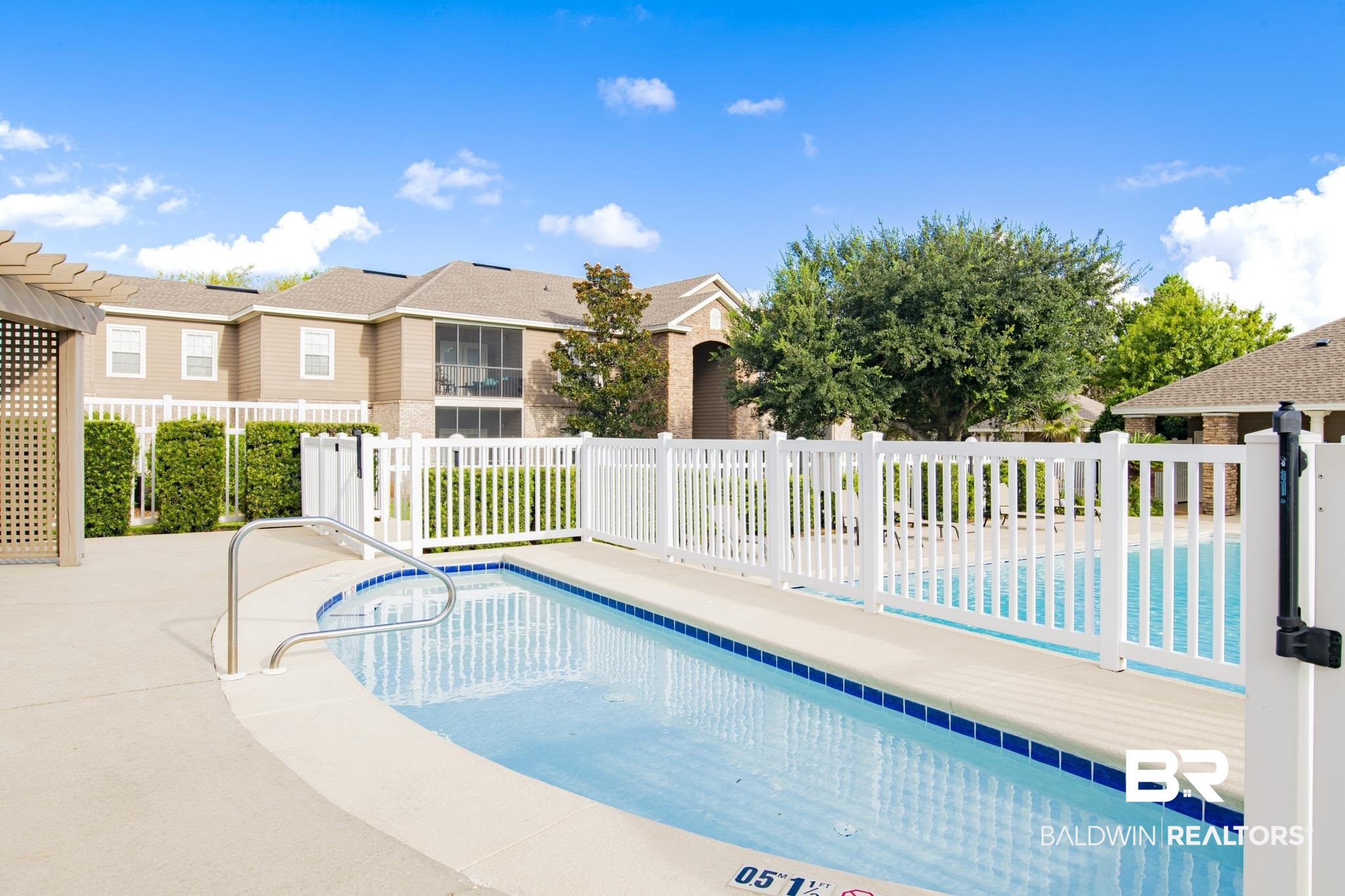 450 Park Avenue, Unit 202 Foley, AL 36535 - Photo 13 of 18 Community pool featuring a residential view and a patio area